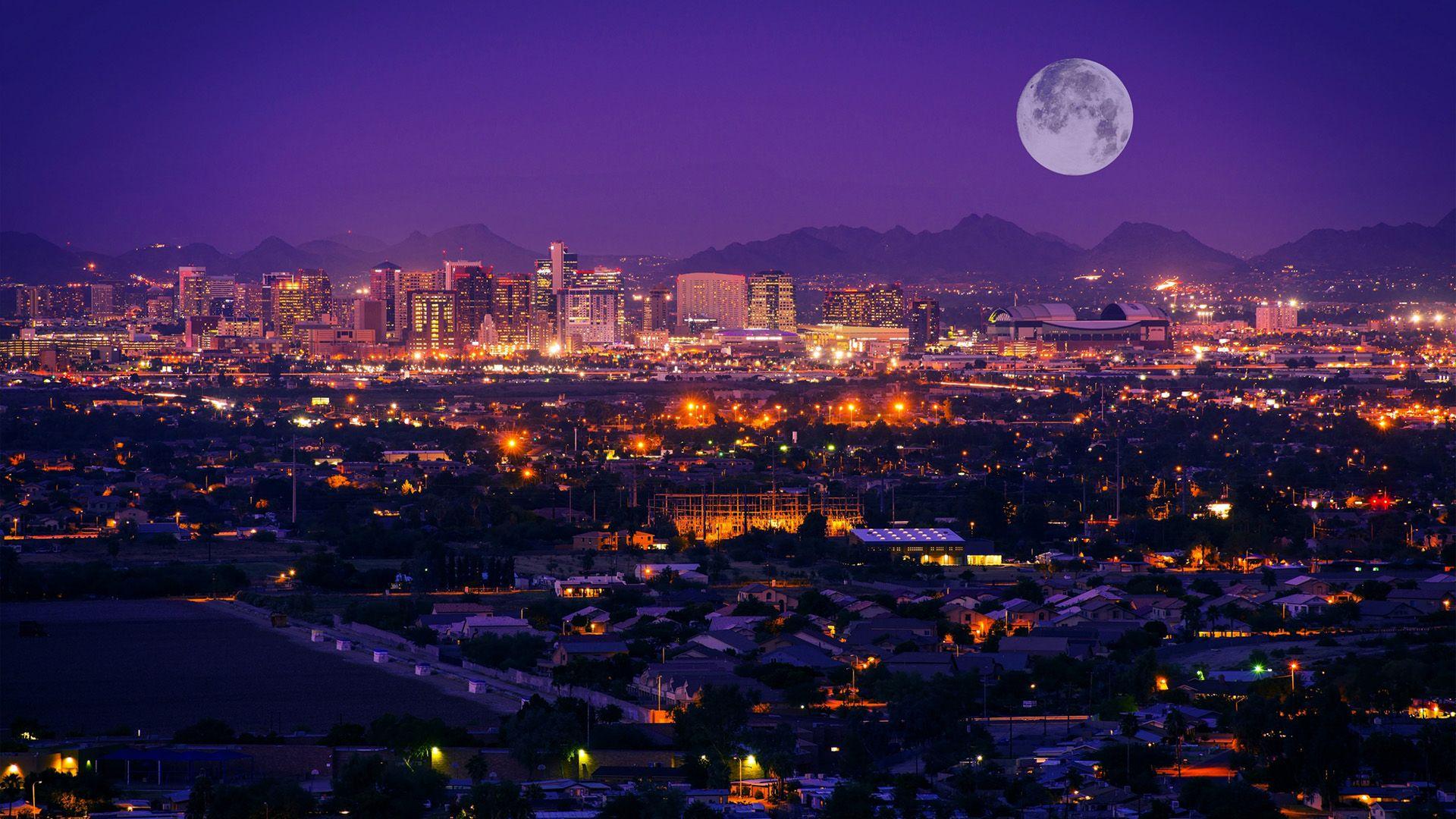 Phoenix, Arizona skyline at night with a full moon