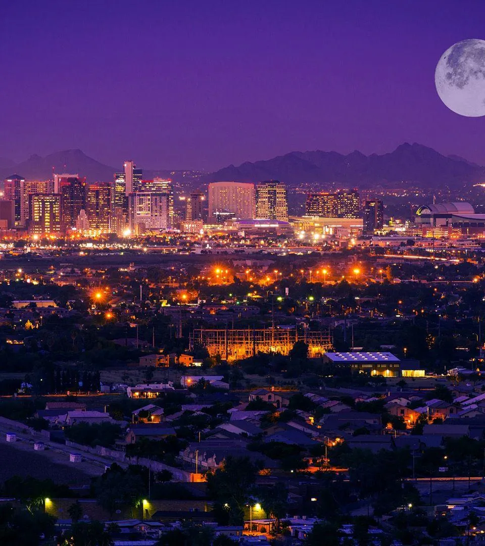 Phoenix, Arizona skyline at night with a full moon